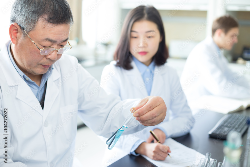 people doing chemical experiment in modern lab people doing chemical experiment in modern lab