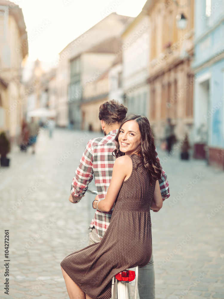 Fototapeta premium Beautiful young woman friend's bike