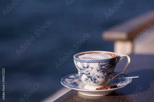 Coffee cup sea in the background