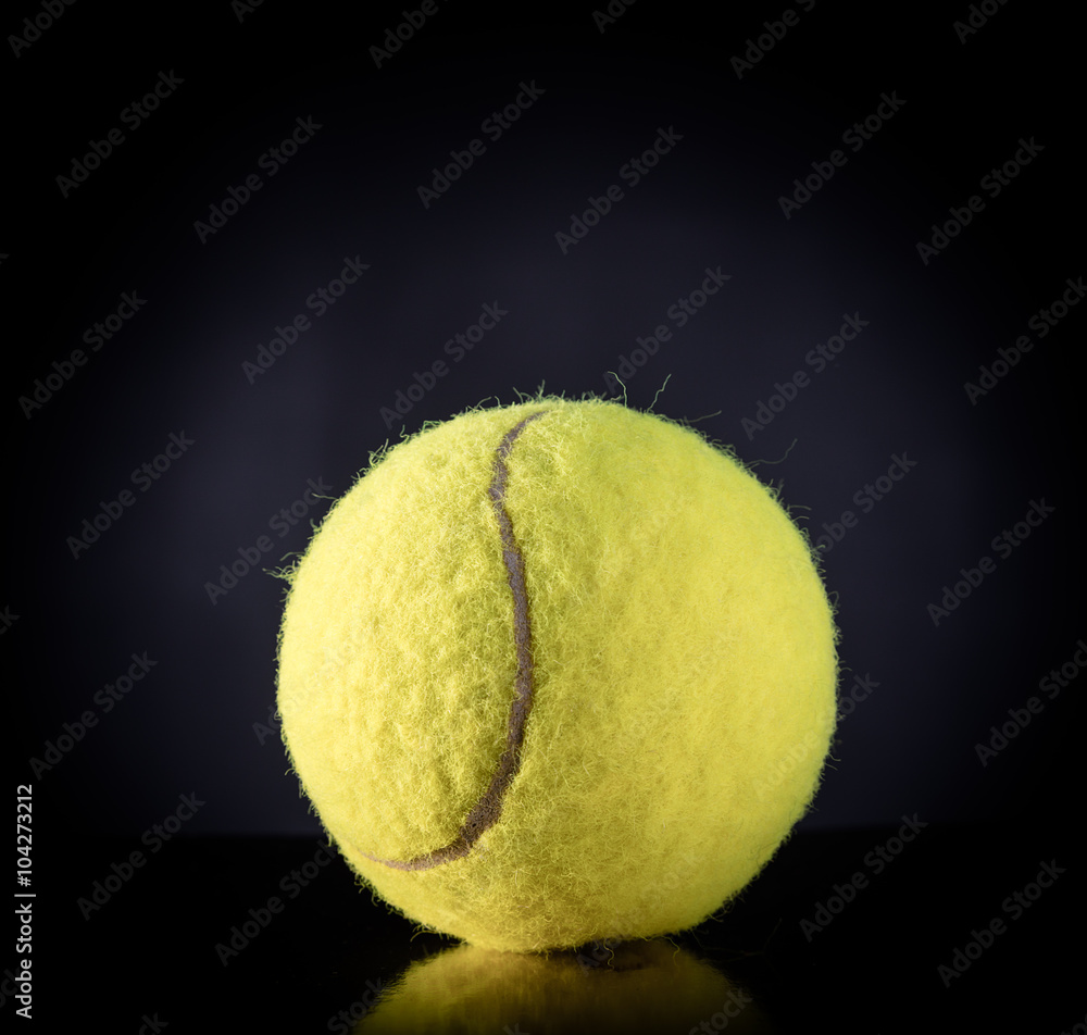 Tennis Ball isolated on black with dramatic lighting
