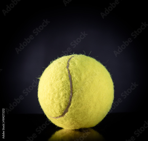 Tennis Ball isolated on black with dramatic lighting © Vitte Yevhen
