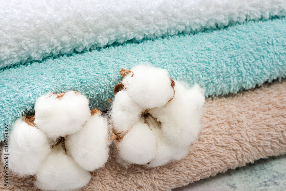 Stack of bath towels with cotton blossom Stack of bath towels with cotton blossom