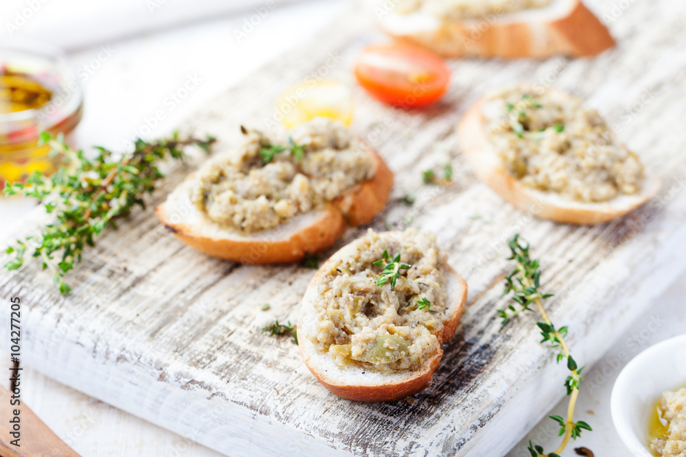 Bruschetta with green olives paste, tapenade on a white wooden background Bruschetta with green olives paste, tapenade on a white wooden background