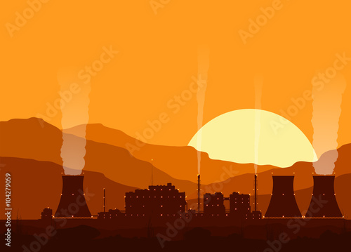 Silhouette of a nuclear power plant at sunset. 