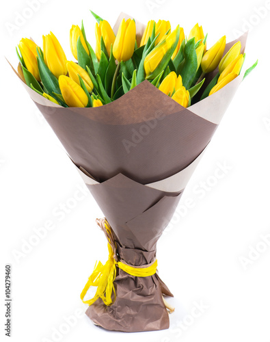 Fototapeta Naklejka Na Ścianę i Meble -  bouquet of 25 yellow tulips in a kraft paper, isolated on white