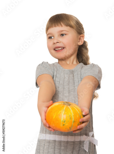 Pretty little blonde girl offers a taste of ripe pumpkin.close-up - Isolated on white background