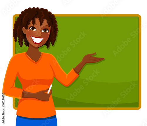 happy tescher standing next to a blackboard