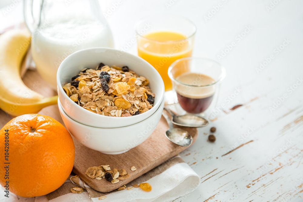 Breakfast - muesli and fruits on white background Breakfast - muesli and fruits on white background