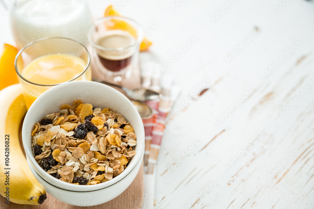 Breakfast - muesli and fruits on white background Breakfast - muesli and fruits on white background