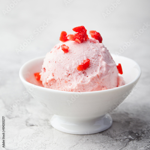 Strawberry sundae ice cream in bowl White stone background Copy space
