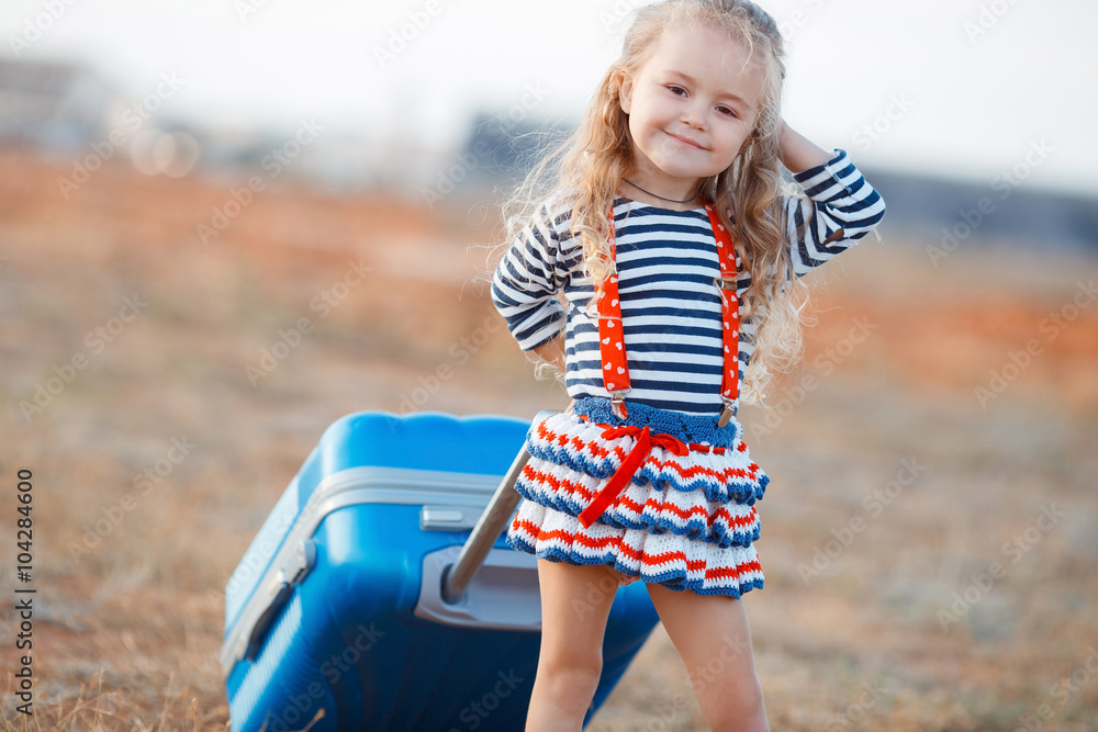 The little girl with a big blue suitcase The little girl with a big blue suitcase