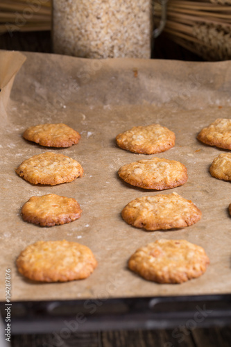 Tasty homemade oat cookies on baking tray.