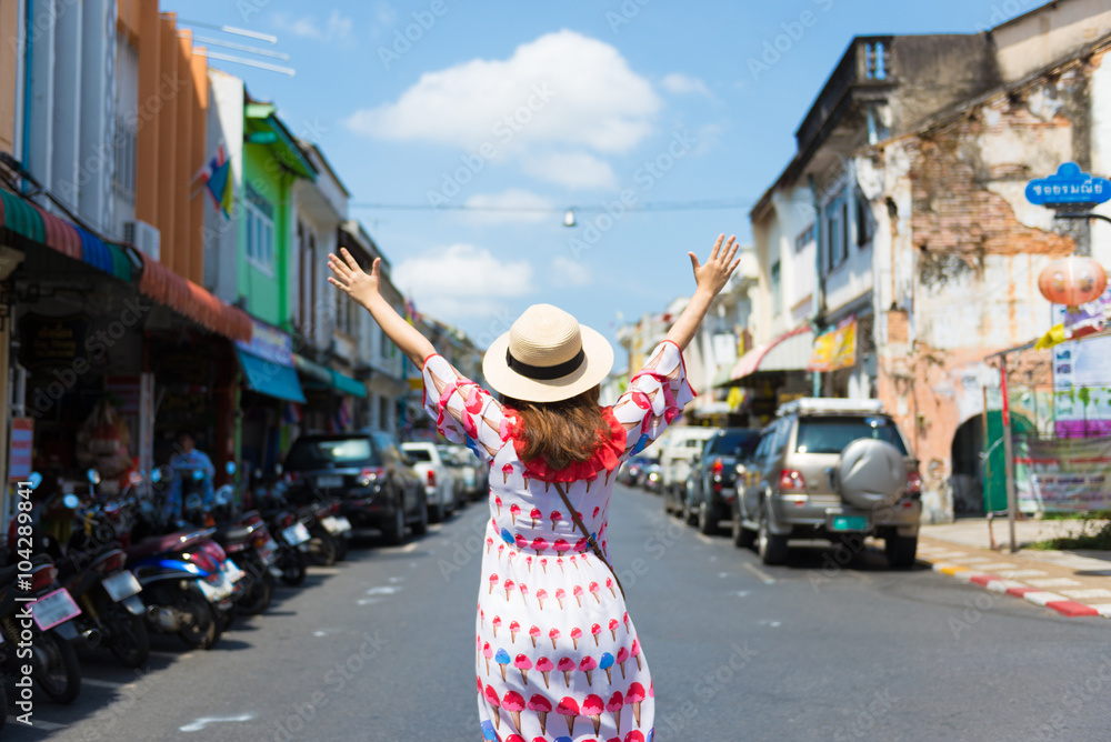 Fototapeta premium Woman enjoy walking in the old town of Phuket.