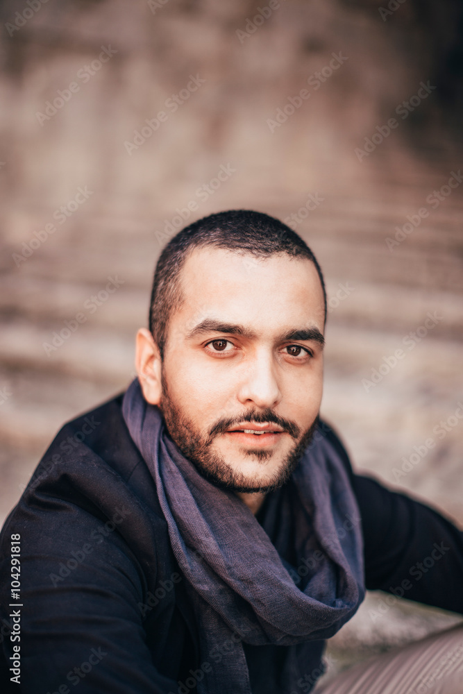 Fototapeta premium Stylish bearded man standing against of white wall and looking a