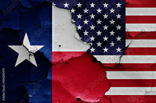 flags of Texas and USA painted on cracked wall