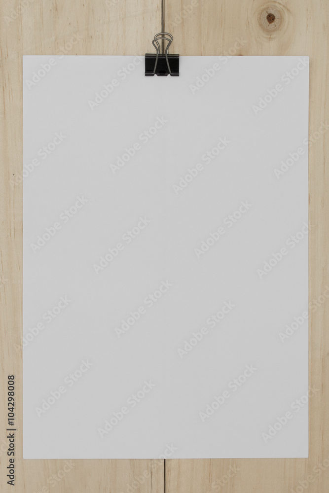 white paper with paperclip on wooden background. white paper with paperclip on wooden background.