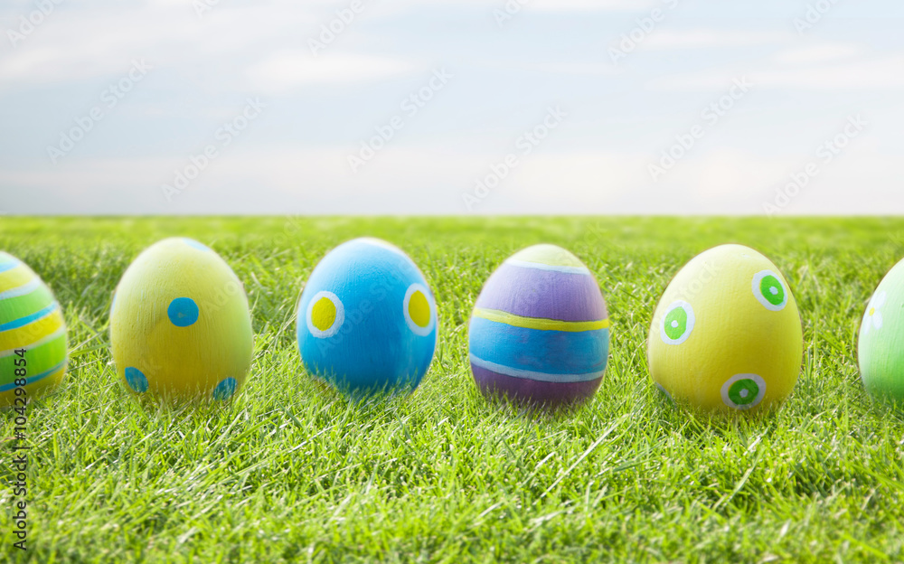 close up of colored easter eggs on wooden surface close up of colored easter eggs on wooden surface
