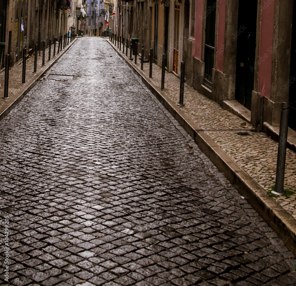 wet cobblestone street lisbon