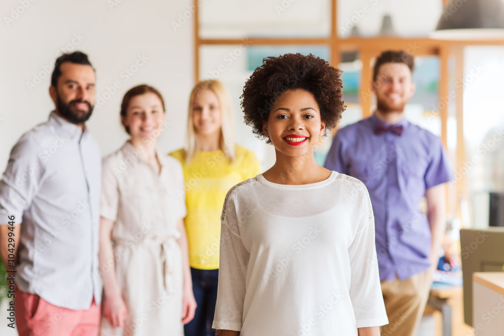 happy young woman over creative team in office happy young woman over creative team in office
