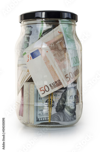 Saving money jar. Dollars and euros in a glass jar. Isolated on white.