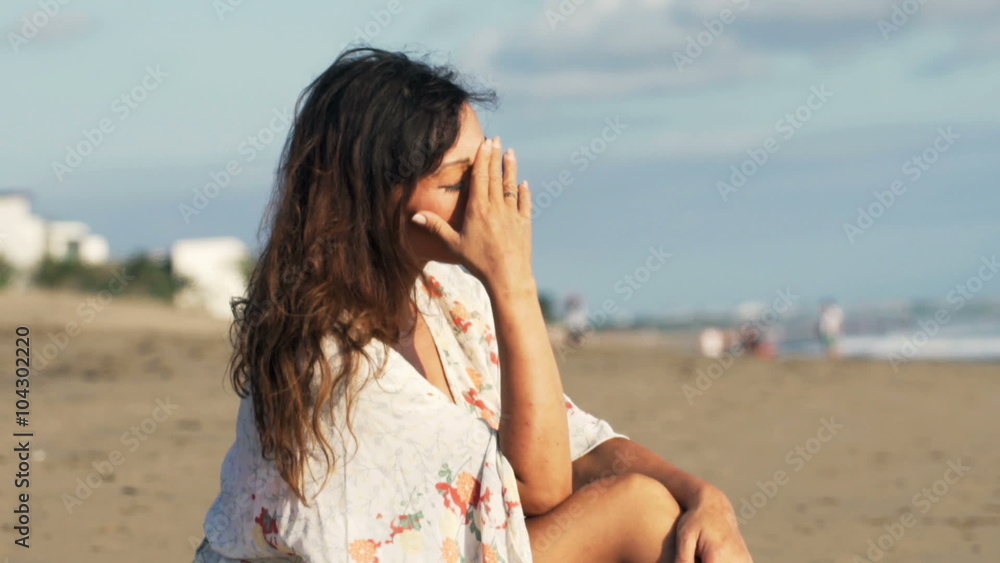 Sad, unhappy woman sitting on beach
Sad, unhappy woman sitting on beach
