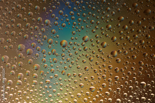 macro shot of liquid droplets with reflection. color background with water drops texture. gradient color