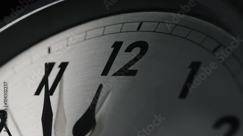 Slow zoom into a clock face as 12 o'clock approaches, 11:55