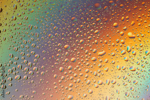 macro shot of liquid droplets with reflection. color background with water drops texture. gradient color
