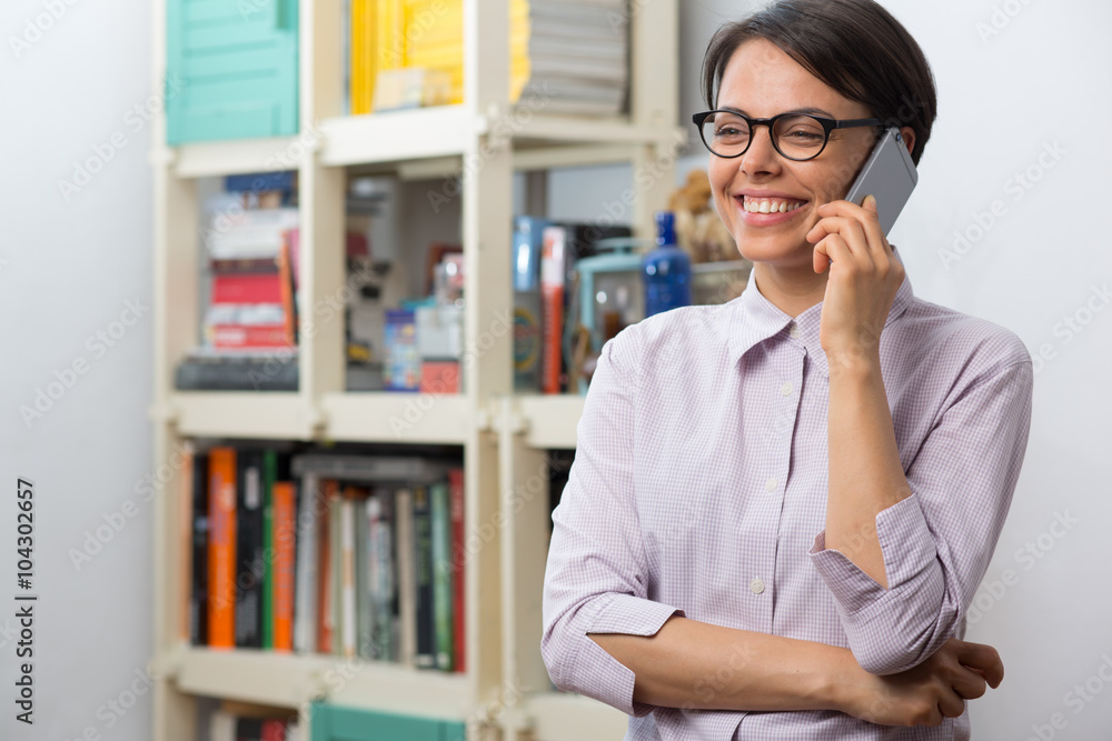 Attractive young woman with glasses talks on her smartphone Attractive young woman with glasses talks on her smartphone