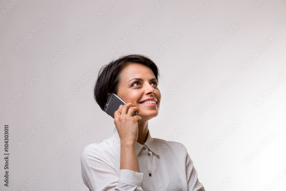 Attractive young business woman talks on her smartphone Attractive young business woman talks on her smartphone