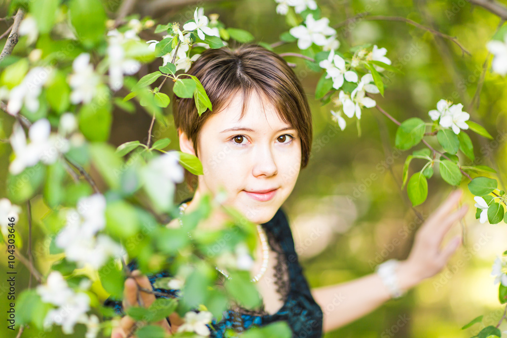 Romantic young woman in the spring garden among apple blossom Romantic young woman in the spring garden among apple blossom