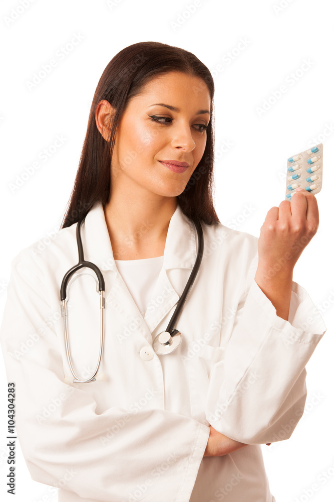 Woman doctor in uniform with stethoscope around neck holding pil Woman doctor in uniform with stethoscope around neck holding pil