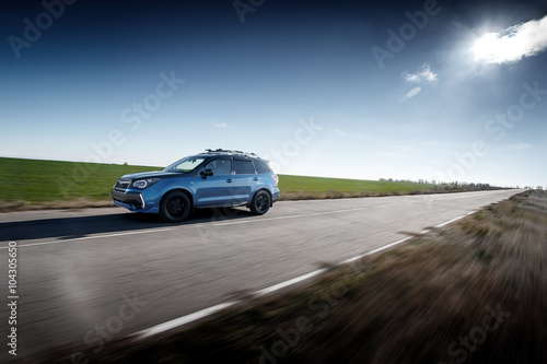 Blue car fast drive on asphalt road at daytime © Ivan Kurmyshov