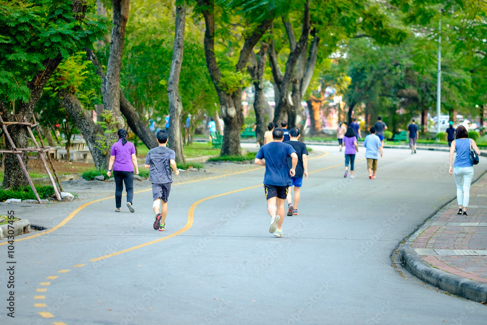 Jogging man running in public park