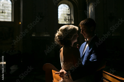 bride and groom illuminated by light