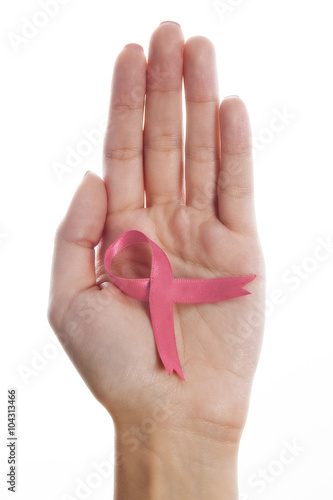 Womans hands holding pink breast cancer awareness ribbon