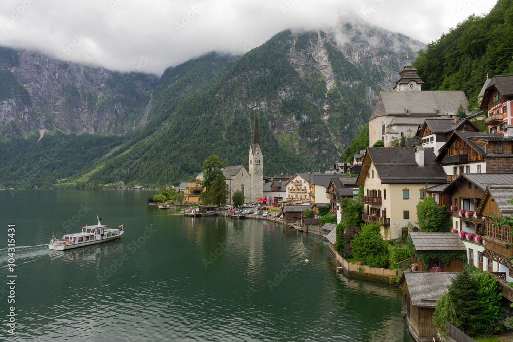 Scenic panoramic picture-postcard view of famous Hallstatt mountain village with Hallstatter See in the Austrian Alps in beautiful golden morning light in fall, Salzkammergut, Austria