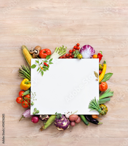 Healthy food background and Copy space / studio photography of white paper surrounded by fresh vegetables on old wooden table. Healthy food background, top view. High resolution product,