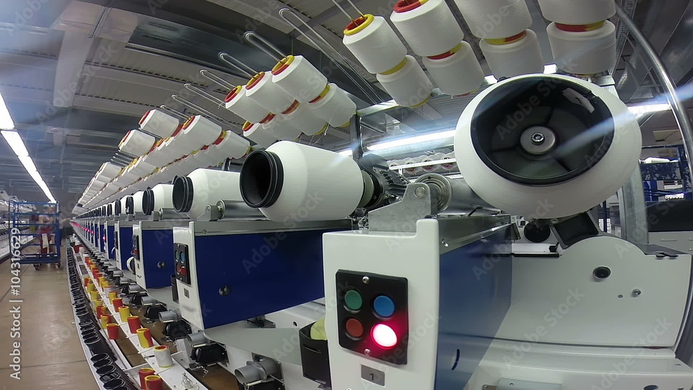 Yarn and Thread Manufacturing in Modern Textile Plant / Large group of automated machines for yarn manufacturing and two female workers in the background. HD1080p. Yarn and Thread Manufacturing in Modern Textile Plant / Large group of automated machines for yarn manufacturing and two female workers in the background. HD1080p.