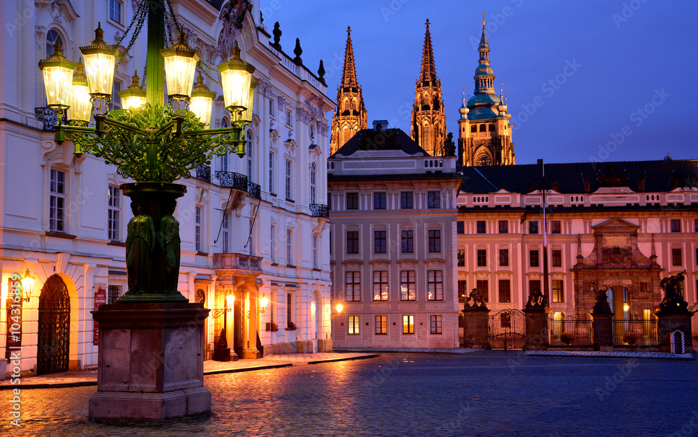 A lantern and Prague castle entrance in the evening