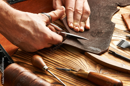 Obraz na plátně Man working with leather
