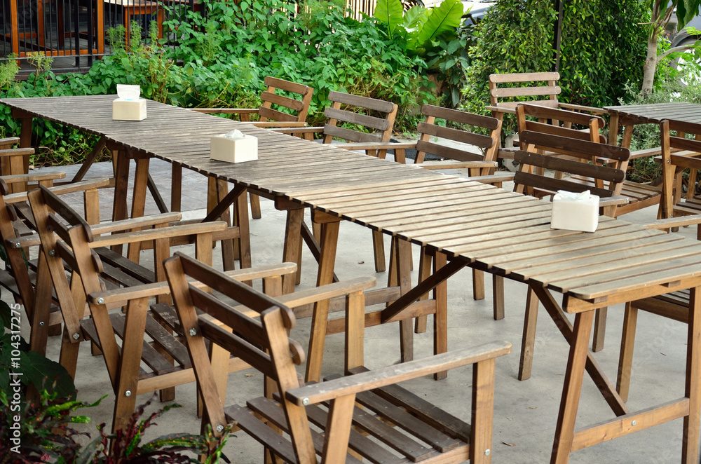 table and chairs standing on a lawn at restaurant or cafe shop table and chairs standing on a lawn at restaurant or cafe shop