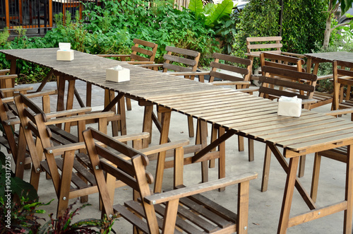 table and chairs standing on a lawn at restaurant or cafe shop