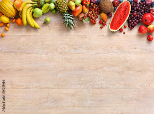 Healthy fruits background / studio photo of different fruits on wooden table