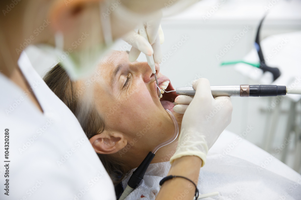 Patient getting her gum pocket depth measured