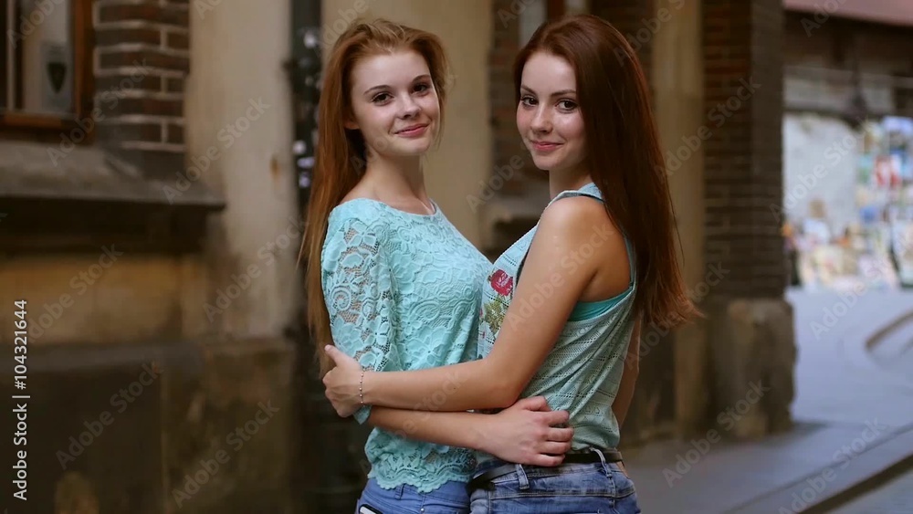 Two pretty girls hugging. They’re best friends. Outdoor photo. Two pretty girls hugging. They’re best friends. Outdoor photo.