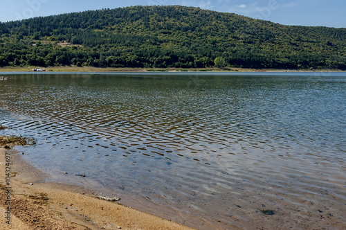 Picturesque Rabisha  lake  with authentic shore, bivouac  and mountain over Magura cave, Belogradchik, Bulgaria photo