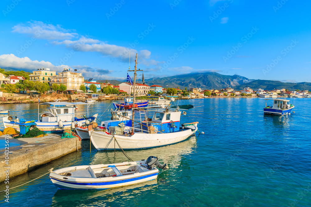 Greek fishing boats at sunrise in small port, Samos island, Greece