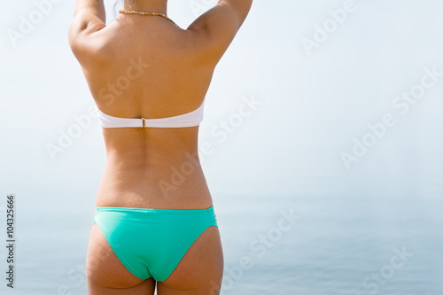 Girl body on the background of the sea