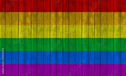 rainbow flag on wood textur...